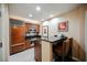 Cozy kitchen features stainless steel appliances, dark countertops, and a breakfast bar with seating for two at 135 E Harmon Ave # 2420, Las Vegas, NV 89109
