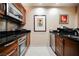 Well-equipped kitchen with modern stainless steel appliances, dark granite countertops, and a sleek minimalist design at 135 E Harmon Ave # 2420, Las Vegas, NV 89109