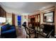 Comfortable living room featuring a plush blue sofa, glass-top table, and entertainment center with a large-screen TV at 135 E Harmon Ave # 2420, Las Vegas, NV 89109