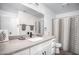 Well lit bathroom features a large mirror, modern fixtures, and a decorative shower curtain at 1512 Bellglen Dr, Las Vegas, NV 89128