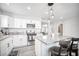Open kitchen with stainless steel appliances, gray countertops, and stylish pendant lighting at 1512 Bellglen Dr, Las Vegas, NV 89128