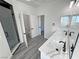 Bathroom with double sink vanity, shower and wood look flooring at 1580 S Tiptop Trl, Pahrump, NV 89048