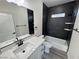 Bathroom features modern white cabinets, black hardware, and black marble-look shower at 1580 S Tiptop Trl, Pahrump, NV 89048