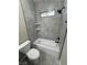 Bathroom featuring modern fixtures, tub and shower combo, and gray tile at 1580 S Tiptop Trl, Pahrump, NV 89048