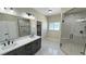 Modern bathroom featuring double vanity, glass shower, and stylish finishes at 1580 S Tiptop Trl, Pahrump, NV 89048