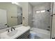 Modern bathroom with gray tiling, white sink, black hardware, and a walk in shower at 1580 S Tiptop Trl, Pahrump, NV 89048
