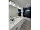 Bright bathroom features a dual sink vanity, black hardware, and decorative tiled shower at 1580 S Tiptop Trl, Pahrump, NV 89048