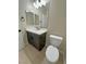 A well-lit bathroom with a modern vanity, sleek faucet, and a toilet, creating a functional space at 1580 S Tiptop Trl, Pahrump, NV 89048