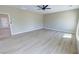 Bright bedroom with light wood flooring, a modern ceiling fan, and neutral wall color at 1580 S Tiptop Trl, Pahrump, NV 89048