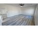 Light-filled bedroom with gray vinyl floors and ceiling fan at 1580 S Tiptop Trl, Pahrump, NV 89048