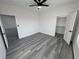 Bedroom features wood-look floors, neutral walls, ceiling fan, closet, and entrance to ensuite at 1580 S Tiptop Trl, Pahrump, NV 89048
