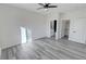 Bedroom featuring closet and bathroom access with gray wood-look flooring at 1580 S Tiptop Trl, Pahrump, NV 89048