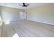 Large bedroom featuring contemporary ceiling fan, wood floors, and neutral paint at 1580 S Tiptop Trl, Pahrump, NV 89048