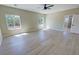 Spacious bedroom with wood floors, a ceiling fan, and scenic views from large windows at 1580 S Tiptop Trl, Pahrump, NV 89048