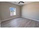Bright bedroom with light gray flooring, neutral walls, and a view from the window at 1580 S Tiptop Trl, Pahrump, NV 89048