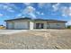 Inviting single-story home with a spacious three-car garage and low-maintenance desert landscaping at 1580 S Tiptop Trl, Pahrump, NV 89048