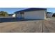 Back exterior shot of a home with a covered patio area and gravel yard at 1580 S Tiptop Trl, Pahrump, NV 89048