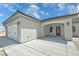 Close up view of the home's three car garage with a view of the front door at 1580 S Tiptop Trl, Pahrump, NV 89048