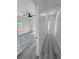Hallway view of a bedroom with modern gray flooring and white walls at 1580 S Tiptop Trl, Pahrump, NV 89048