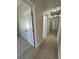 Bright hallway with wood-look floors and multiple doors leading to other rooms at 1580 S Tiptop Trl, Pahrump, NV 89048
