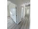 Hallway with modern gray flooring and white doors with black hardware at 1580 S Tiptop Trl, Pahrump, NV 89048