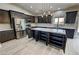 Modern kitchen with stainless steel appliances, sleek countertops, and stylish dark cabinetry at 1580 S Tiptop Trl, Pahrump, NV 89048