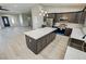 Modern kitchen with stainless appliances, stylish island, light countertops, and ample wood cabinetry at 1580 S Tiptop Trl, Pahrump, NV 89048