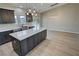 Modern kitchen featuring a kitchen island, stainless steel appliances, and modern lighting at 1580 S Tiptop Trl, Pahrump, NV 89048