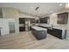 Spacious kitchen features an island, stainless appliances, wood cabinets, pantry, and light countertops at 1580 S Tiptop Trl, Pahrump, NV 89048