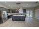 Well-lit kitchen features an island, stainless steel appliances, and a view overlooking the desert at 1580 S Tiptop Trl, Pahrump, NV 89048