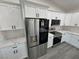 Modern kitchen with stainless steel appliances, white cabinets, marble countertops and black hardware at 1580 S Tiptop Trl, Pahrump, NV 89048