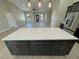 Stylish kitchen island with light countertops and wood cabinets; open to the spacious floorplan at 1580 S Tiptop Trl, Pahrump, NV 89048