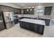 Stylish kitchen featuring stainless steel appliances, dark wood cabinetry, a kitchen island, and modern lighting at 1580 S Tiptop Trl, Pahrump, NV 89048