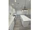 Bright kitchen boasts white cabinets, marble countertops, modern stainless steel appliances, and pendant lighting at 1580 S Tiptop Trl, Pahrump, NV 89048