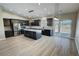 Bright, open kitchen boasts an island, stainless appliances, wood cabinets, and light countertops at 1580 S Tiptop Trl, Pahrump, NV 89048