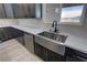Modern kitchen featuring a stainless steel apron sink, sleek appliances, and dark wood cabinets at 1580 S Tiptop Trl, Pahrump, NV 89048