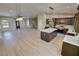 Open-concept kitchen features an island, stainless appliances, wood cabinets, and light countertops at 1580 S Tiptop Trl, Pahrump, NV 89048