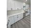 Stylish kitchen features white cabinets, marble countertops, undermount sink, black hardware, and stainless steel appliances at 1580 S Tiptop Trl, Pahrump, NV 89048