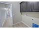 Laundry room featuring cabinets, neutral walls, and views into the hallway at 1580 S Tiptop Trl, Pahrump, NV 89048