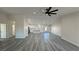 Open floor plan with gray floors, a large ceiling fan, and a combined living room and kitchen at 1580 S Tiptop Trl, Pahrump, NV 89048
