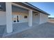 Covered back patio area with bright white support columns and concrete floor at 1580 S Tiptop Trl, Pahrump, NV 89048