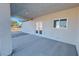 Cozy covered patio featuring double glass doors and a window, inviting natural light and desert views at 1580 S Tiptop Trl, Pahrump, NV 89048