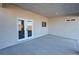 Covered patio area features double doors and a window, with a view of the flat desert landscape at 1580 S Tiptop Trl, Pahrump, NV 89048