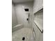 Modern shower featuring niche shelving, a corner seat, and herringbone tile at 1580 S Tiptop Trl, Pahrump, NV 89048