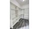 Spacious walk-in closet with plenty of shelving and storage with gray vinyl floors at 1580 S Tiptop Trl, Pahrump, NV 89048