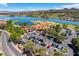Beautiful aerial view of a lakeside community featuring a clubhouse, parking, and manicured landscaping at 1600 Pleasant Bay Ct, Henderson, NV 89011