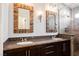 Modern bathroom features dual sinks, granite countertops, and wood frame mirrors at 209 Camino Vista St, Henderson, NV 89012