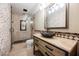 Stylish bathroom featuring a stone sink, decorative tile, and glass shower with a unique design at 209 Camino Vista St, Henderson, NV 89012