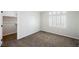 A bright bedroom with neutral carpet, a large closet and a window with white shutters at 209 Camino Vista St, Henderson, NV 89012