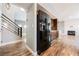 Modern hallway with wood floors leading to staircase and open living area at 209 Camino Vista St, Henderson, NV 89012
